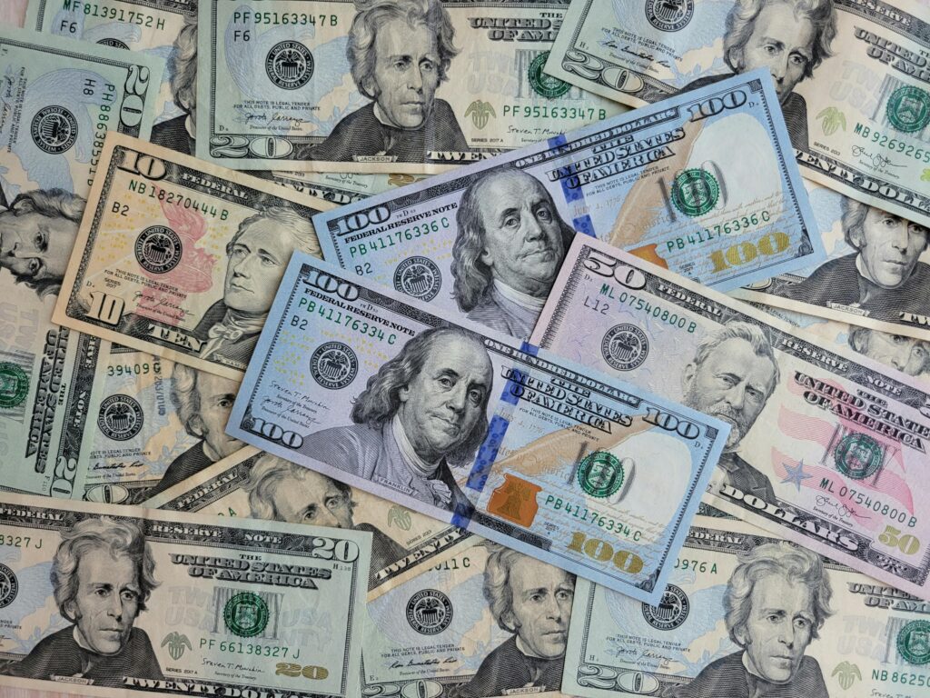 A flat lay of assorted US dollar banknotes highlighting wealth and finance.